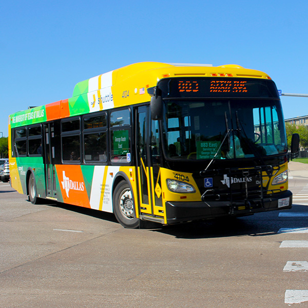 A Comet Cruiser bus is parked in the circle drive near the Margaret McDermott Mall.