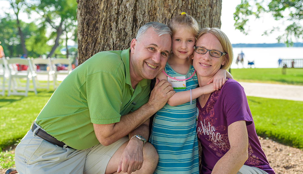 Jako Garos MBA’94 and wife Sharon pose for a family photo with their daughter Aurora to commemorate the event.