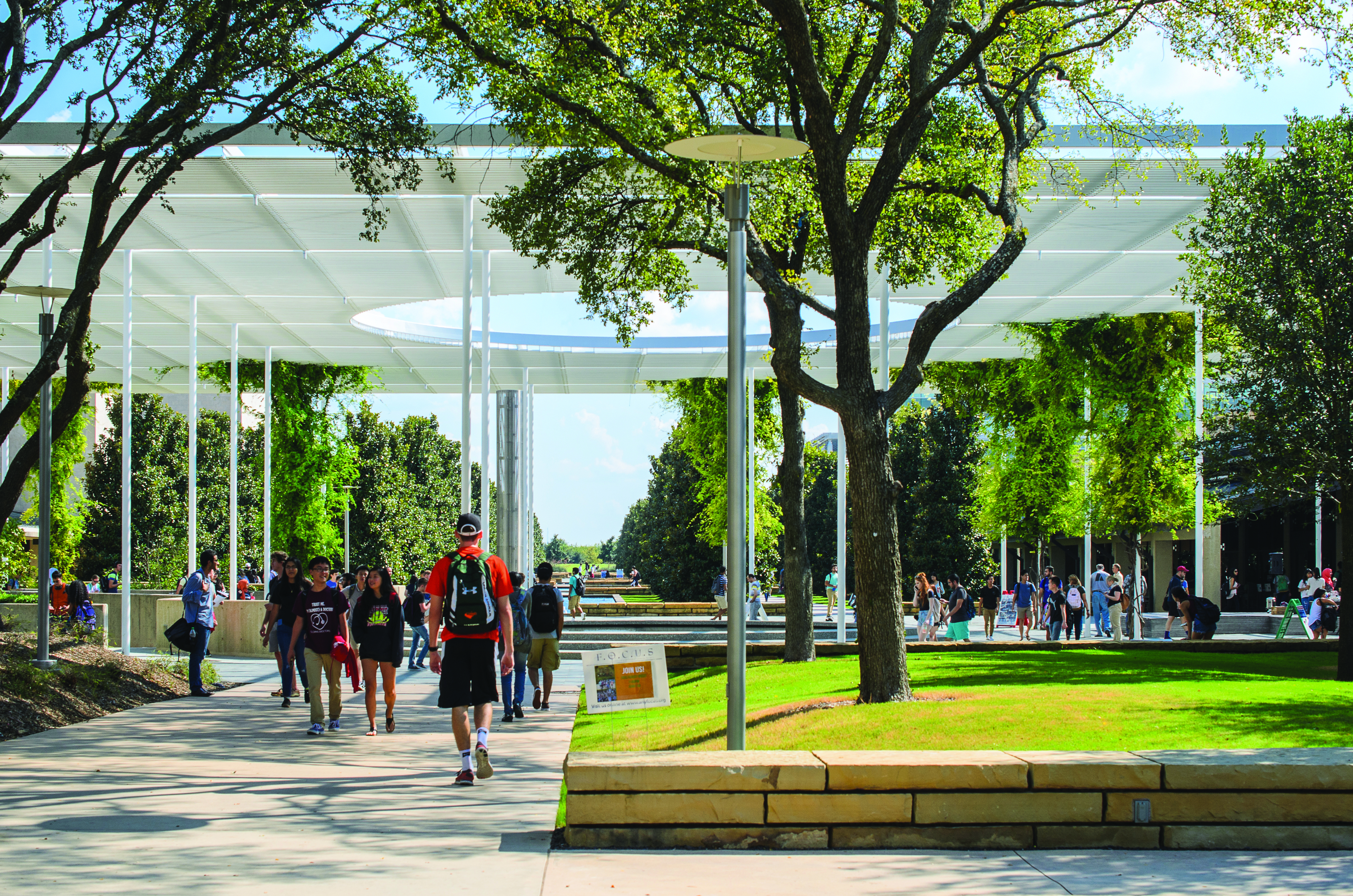 Students walking along the mall near Trellis Plaza.