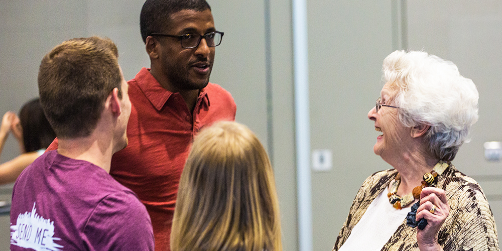 Sirak Asfaw MS’12, chats with Elaine Whitney BS’83 and other alumni.