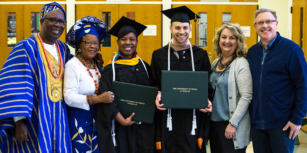 Sahadath M.J. Mowery and Colby smile with their parents at graduation