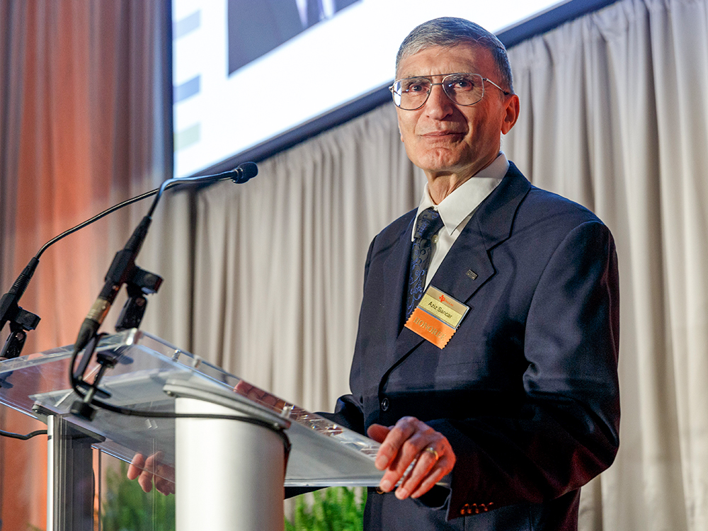 Photo of Aziz Sancar standing at a podium