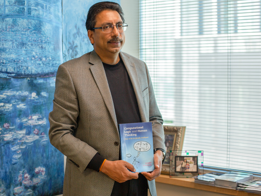 Man standing in office with book