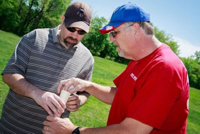 Alan Harrison, a physics graduate student, works with Dr. Phil Anderson to prepare a rocket for launch. Harrison and Anderson are members of the National Association of Rocketry.