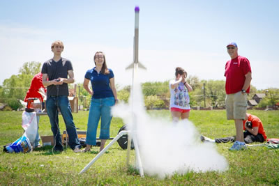 Matthew Henderson launches his team’s rocket with teammate Mikaela McMurtry.